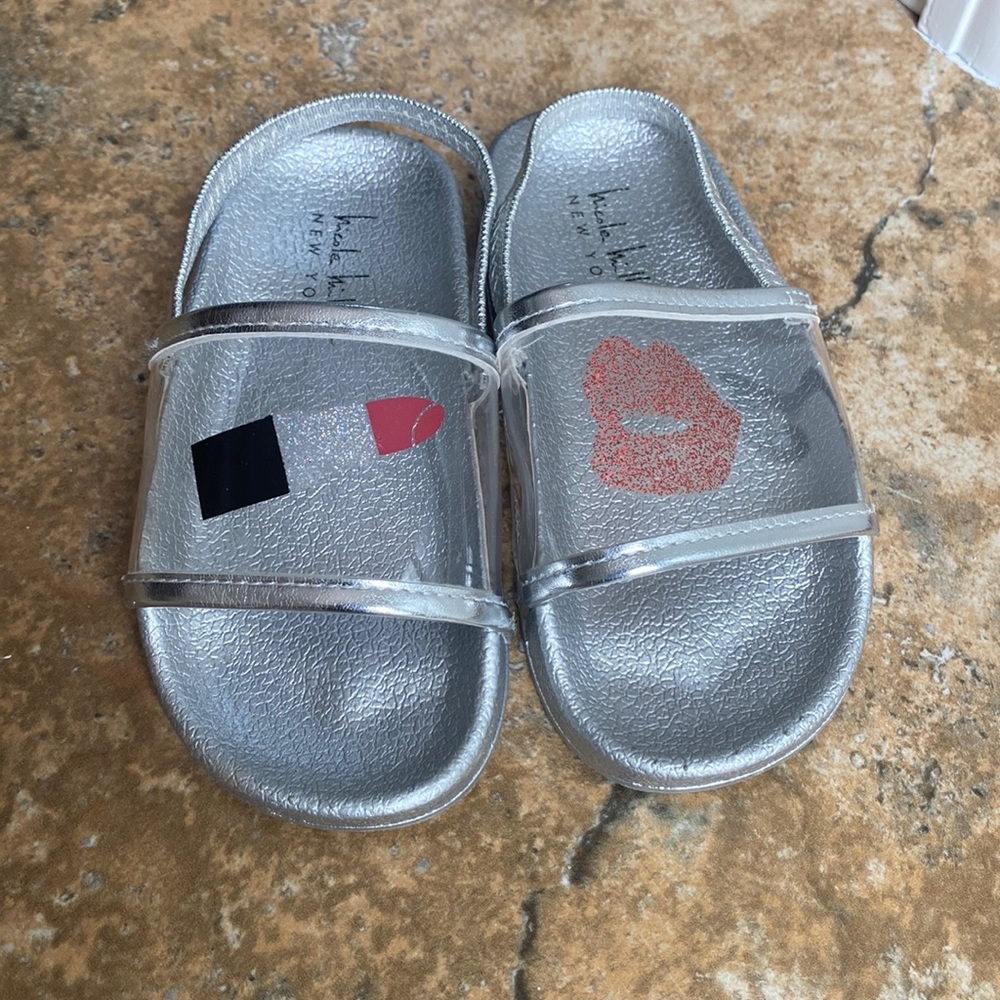 Toddler girl Nicole Miller slides